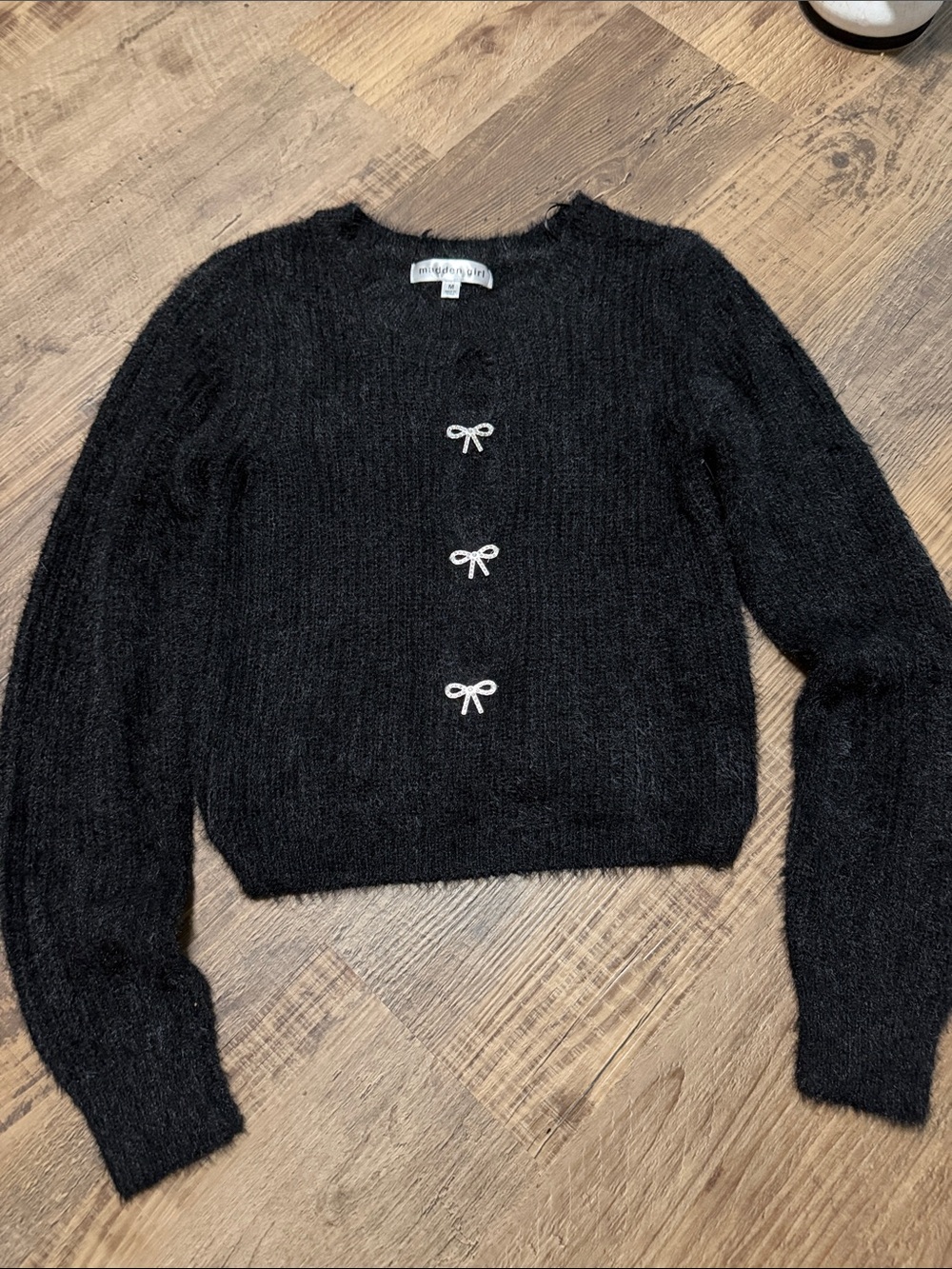 Madden Women’s Black Fuzzy Cropped Cardigan with Bow Accents